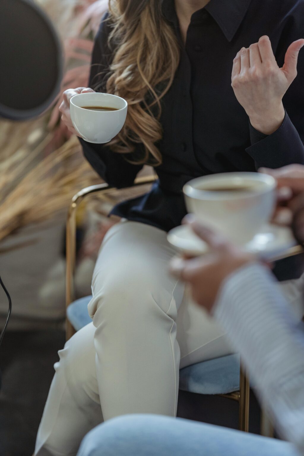 Picture of two women discussing sponsorships over coffee.