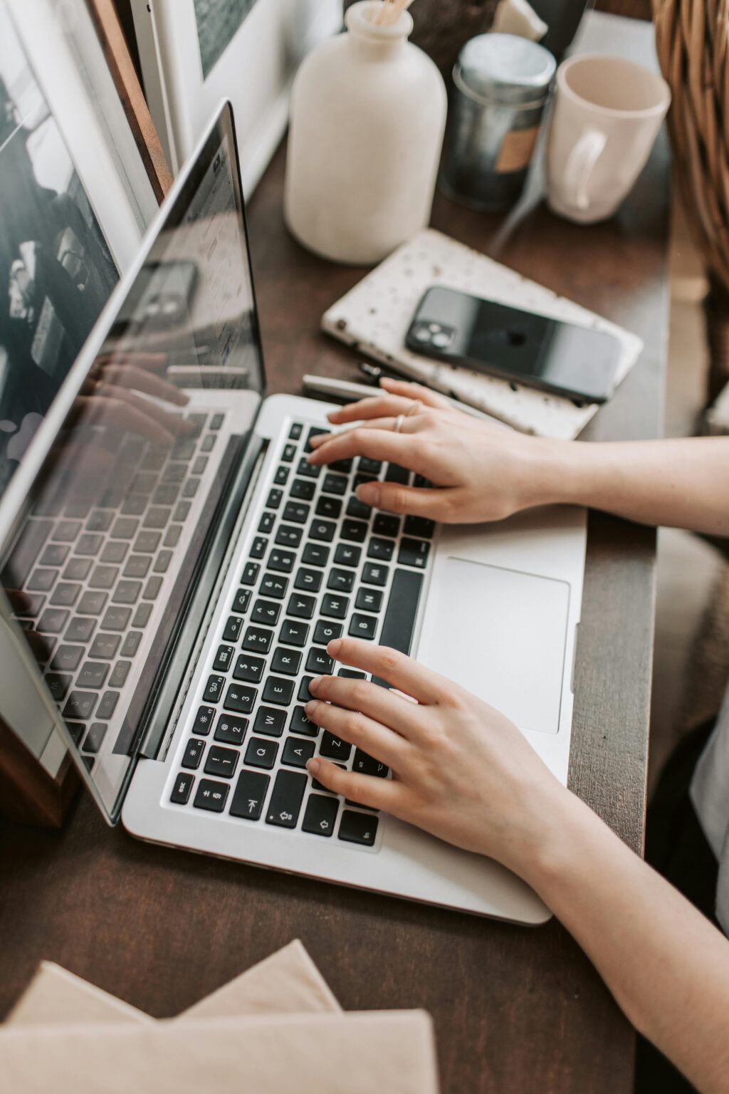 A woman sitting at her laptop writing an email sequence for her list.