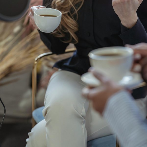 Picture of two women discussing sponsorships over coffee.