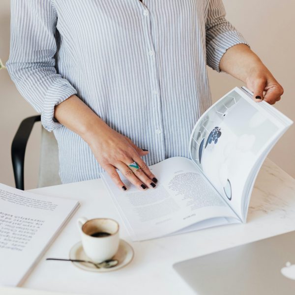 Woman reading a magazine trying to figure out what her opt-in offer should be.